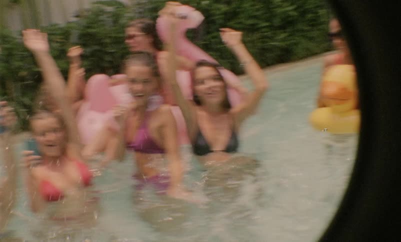 Teenage girls play in a swimming pool