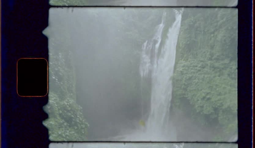 A waterfall splashing into a lake below
