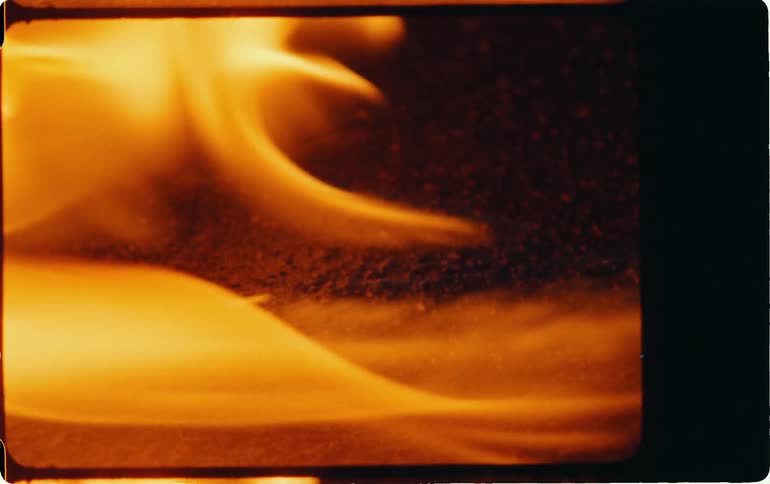 Fire burns on the ground at night