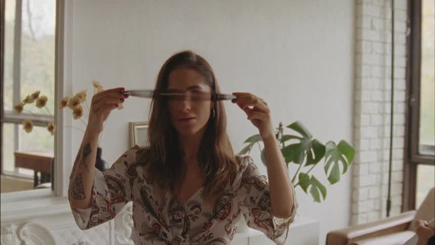 A woman spinning a vinyl disk in front of her face