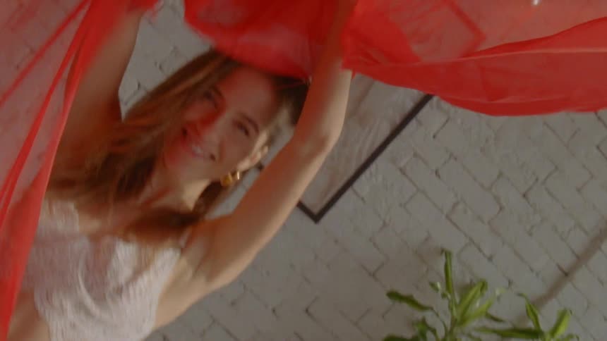 Female playing with red scarf