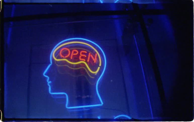 A neon sign that says open