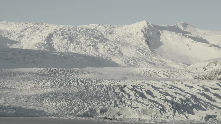 Snow covers a mountainous landscape