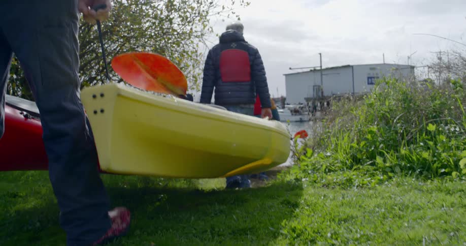 Men bring boat to the water