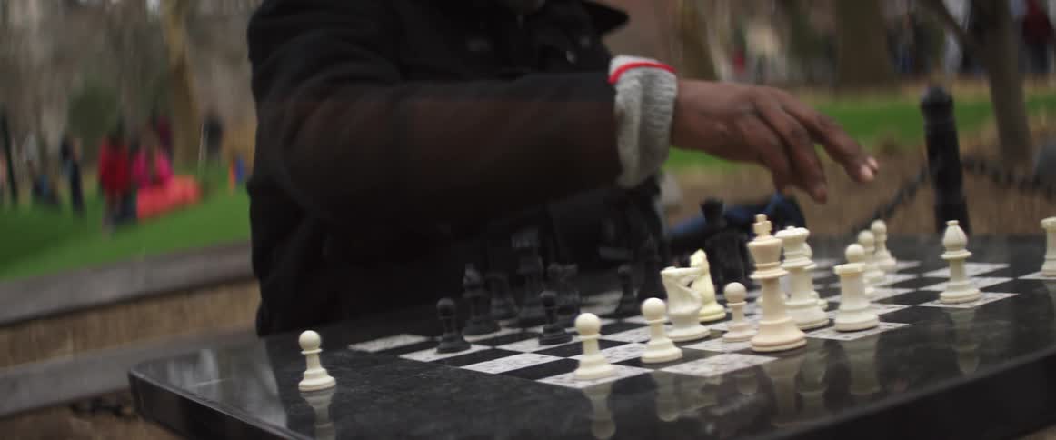Man moving chess piece