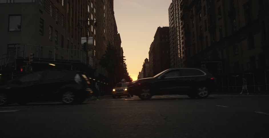 View of scaffolding, walkways, buildings and traffic in a city at dusk