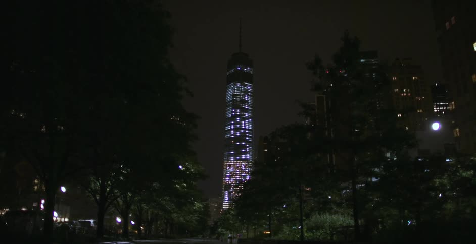 A skyscraper towers overhead at night