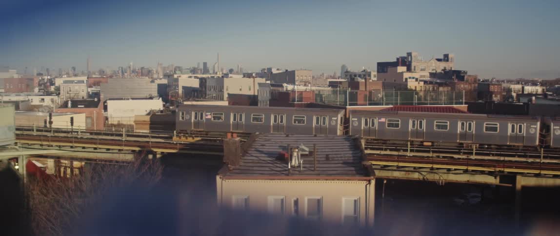 A train pulls out of a station in a city