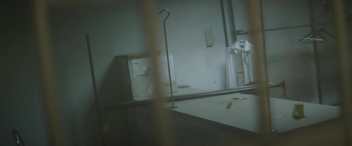 A shirt hangs in an empty room
