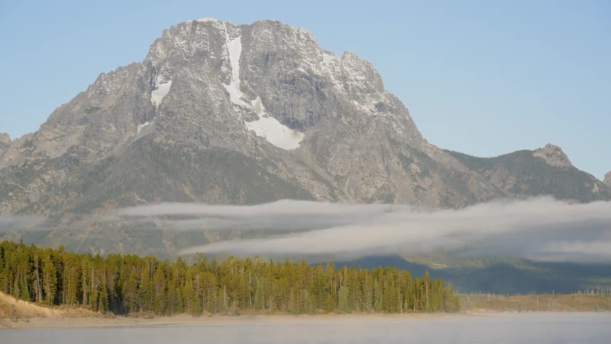 Mist hovering before a mountain during the day