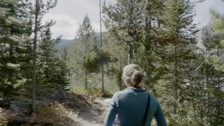Woman hiking on a trail in the wilderness