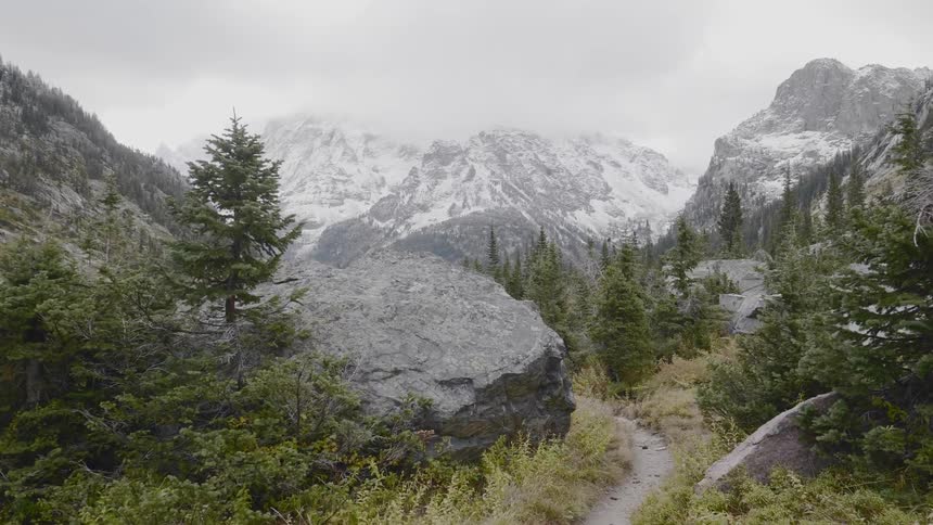 A narrow dirt path winding through a mountain ridge