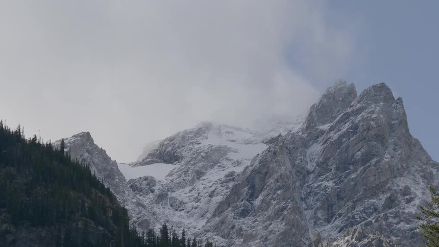 Clouds cover the snowy mountain range