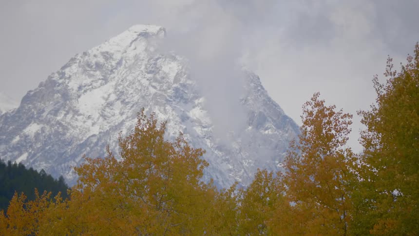 A mountain covered in snow is in the horizon