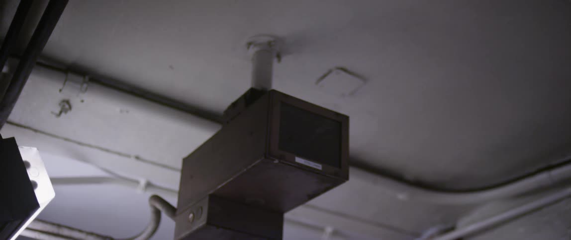 A camera hangs from the ceiling