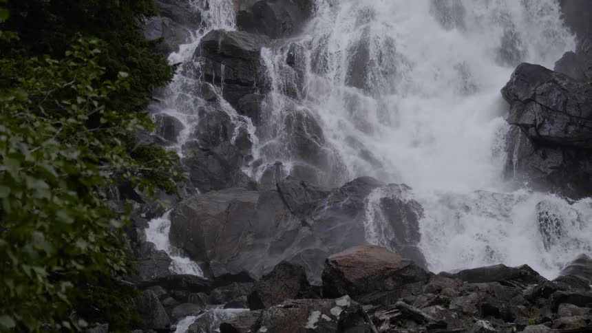 A waterfall crashes over rocks