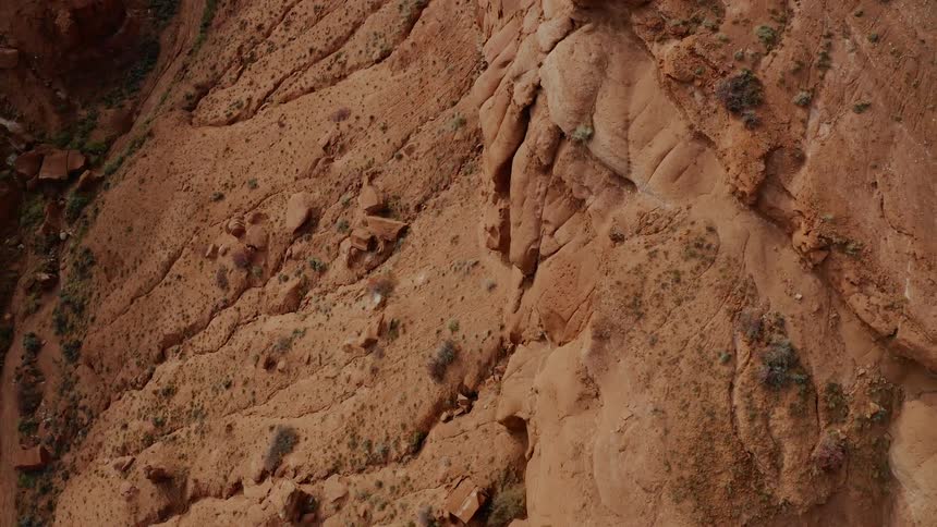 Striations and boulders on red rock in a canyon