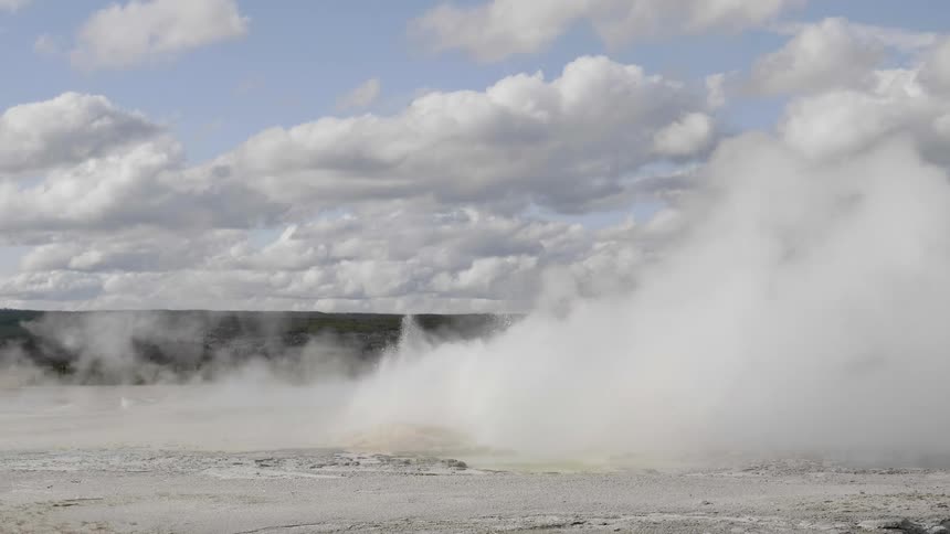 Water splashes up from a puddle as steam goes across the land