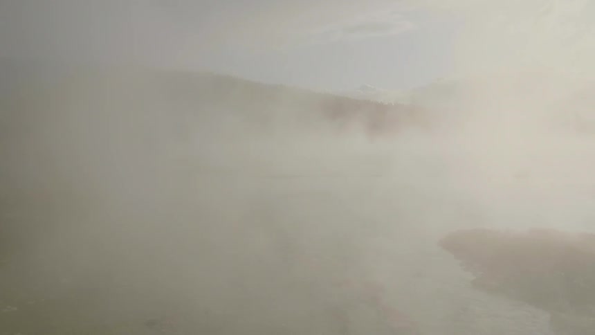 Steam rises above the water