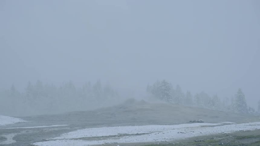 Snow falling over a geiser