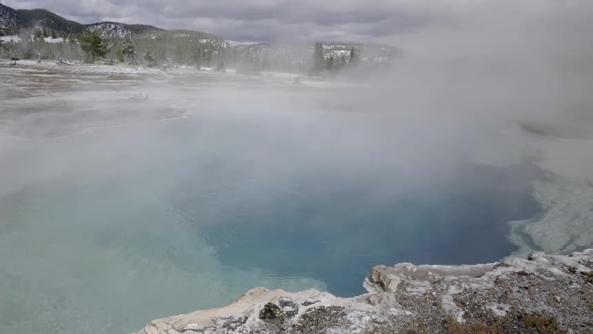 Steam rises above the water