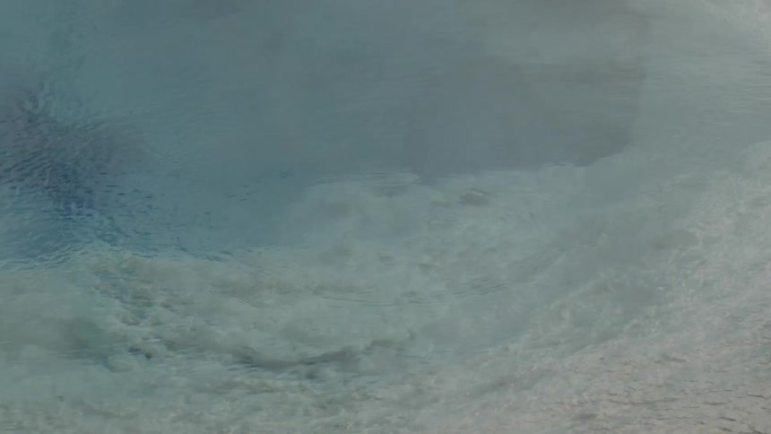 Clear water ripples over a rocky ocean bed