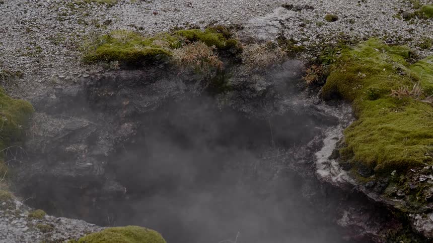 Birds eye view of steam rising from a hole in the ground