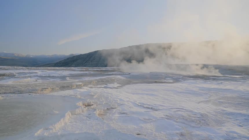 Landscape view of steam rising off the ice covered water