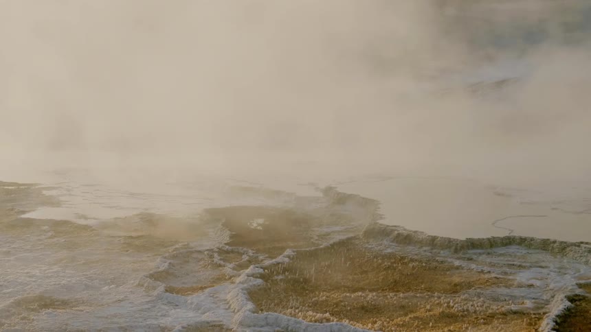 Fog and clouds move over a snow dusted landscape