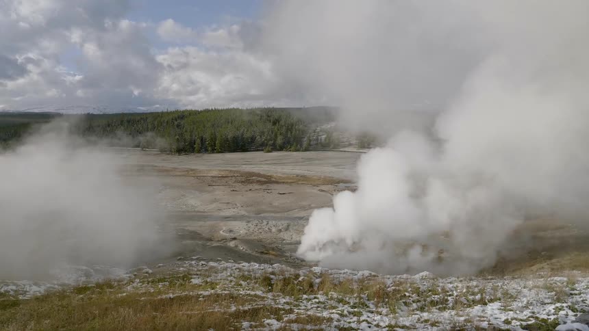 Huge plumes of steam billow from the ground located at a group of natural springs and geysers