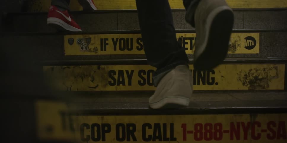 A slow-motion clip of the legs of two teenagers as they ascend a flight of stairs