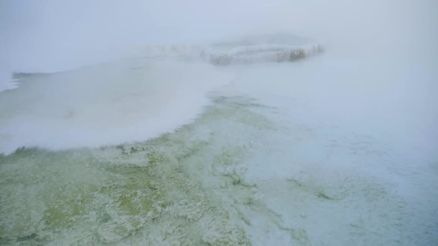 An aerial view of a foggy hill