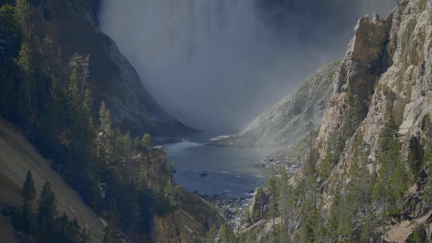 The waterfall is pouring down the mountain
