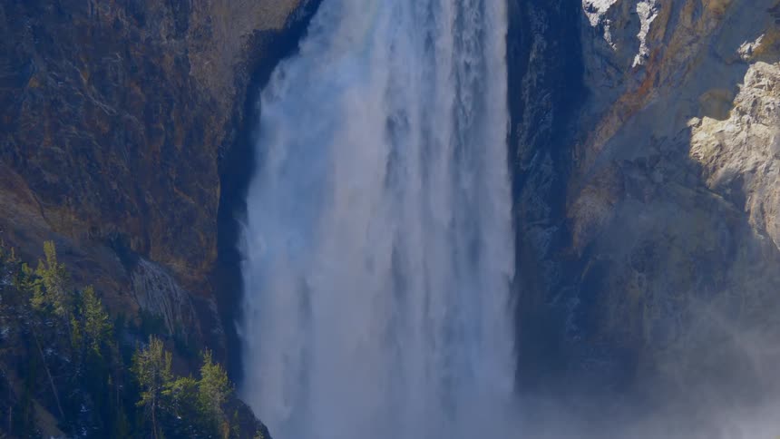Close up view of waterfall rushing down from the cliff