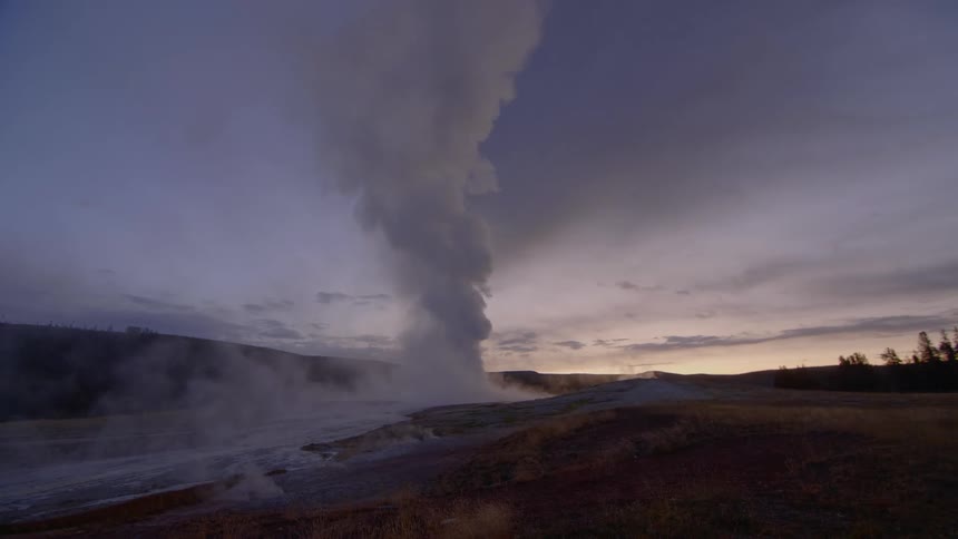 A geyser that is erupting in the middle of a field