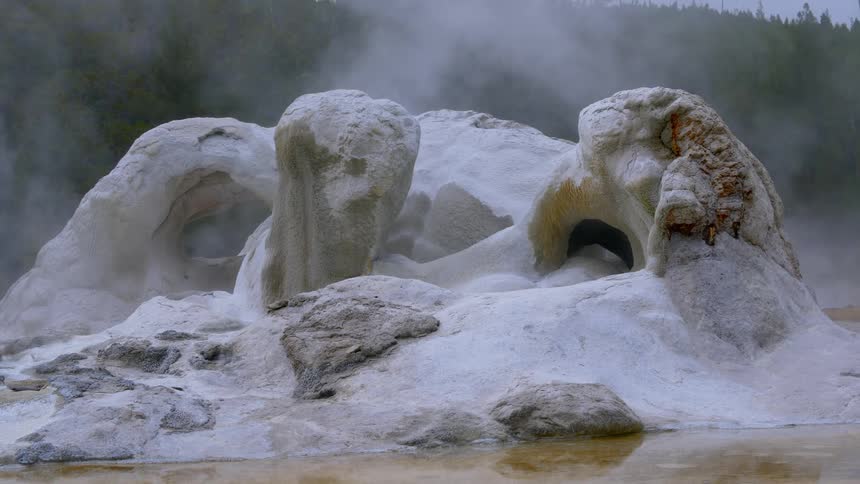 A hot spring with rocks water and ash