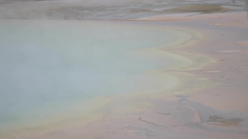 A smoky lake surrounded by sand