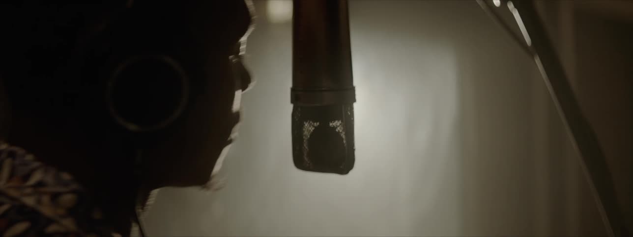 A man sings into the microphone