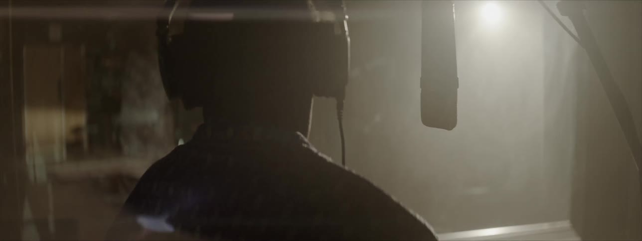 Singer on studio singing at microphone