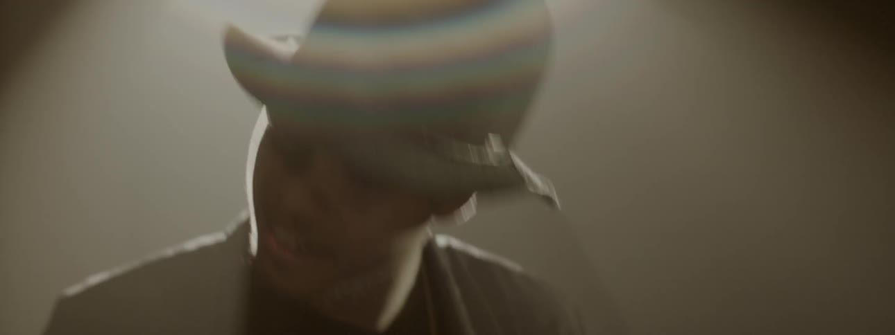 A man is playing drums and rocking his head