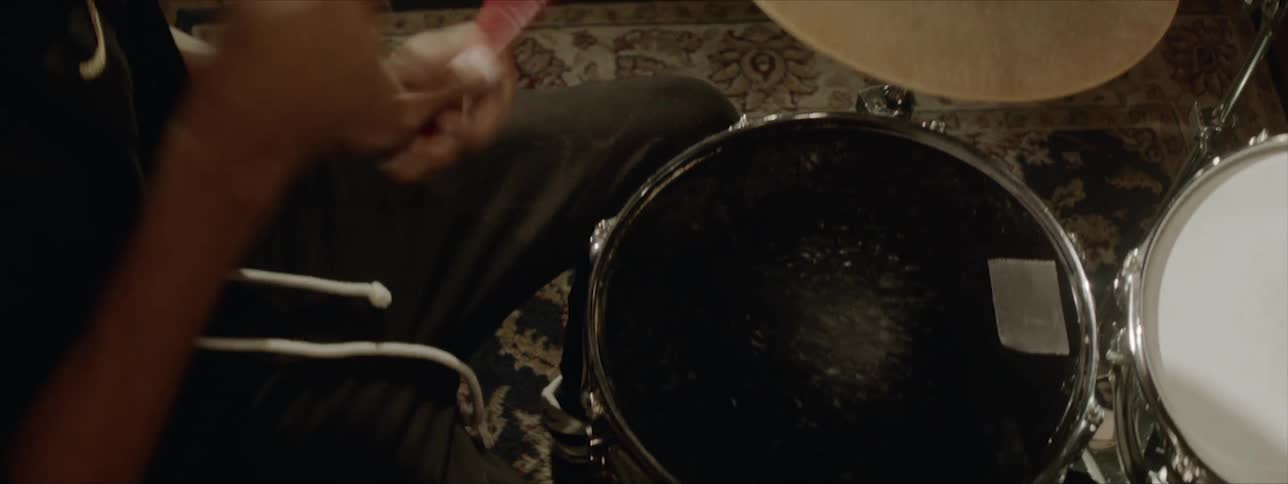 A person plays a drum set