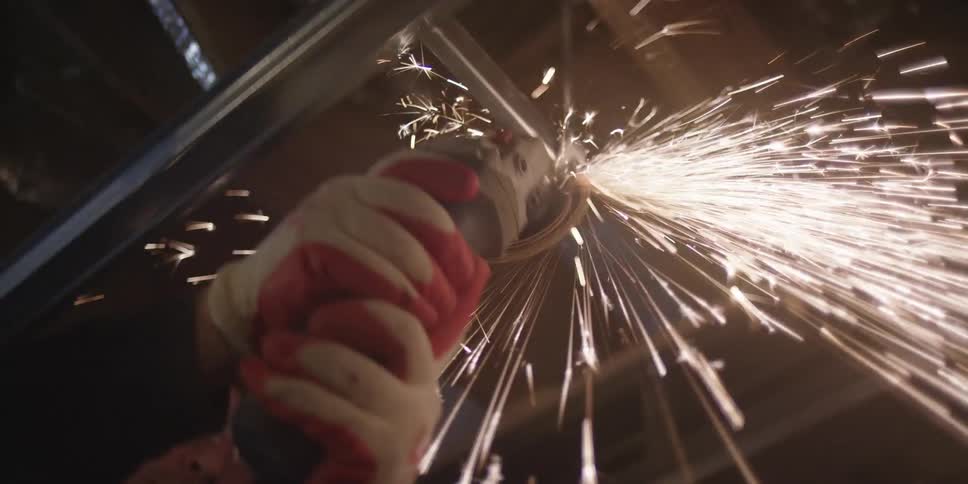 Someone sawing a metal bar