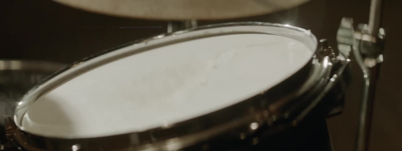 A close view of a drumset being played by a person