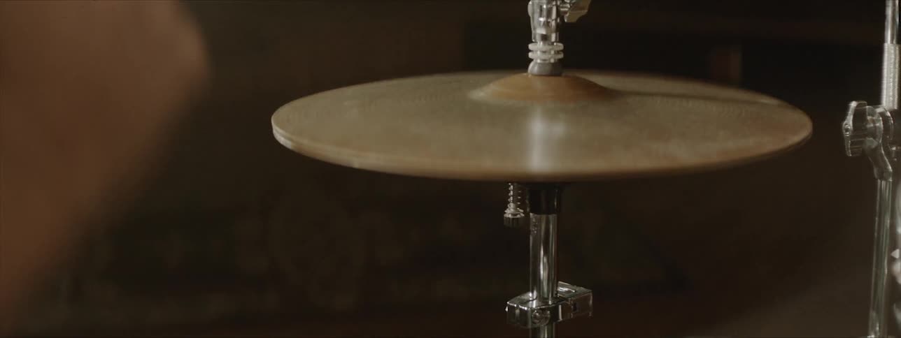 Black drummer plays drums at the stage