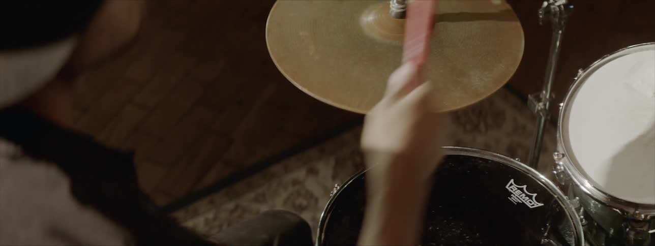 A person plays a drum set