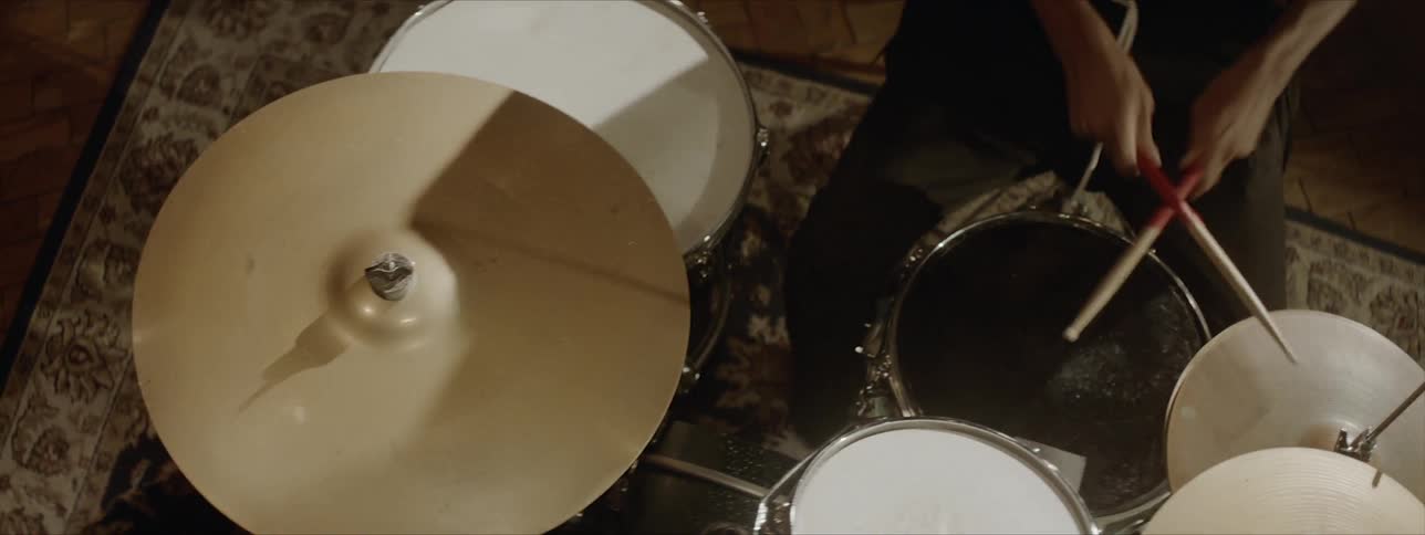 A man playing drums indoors