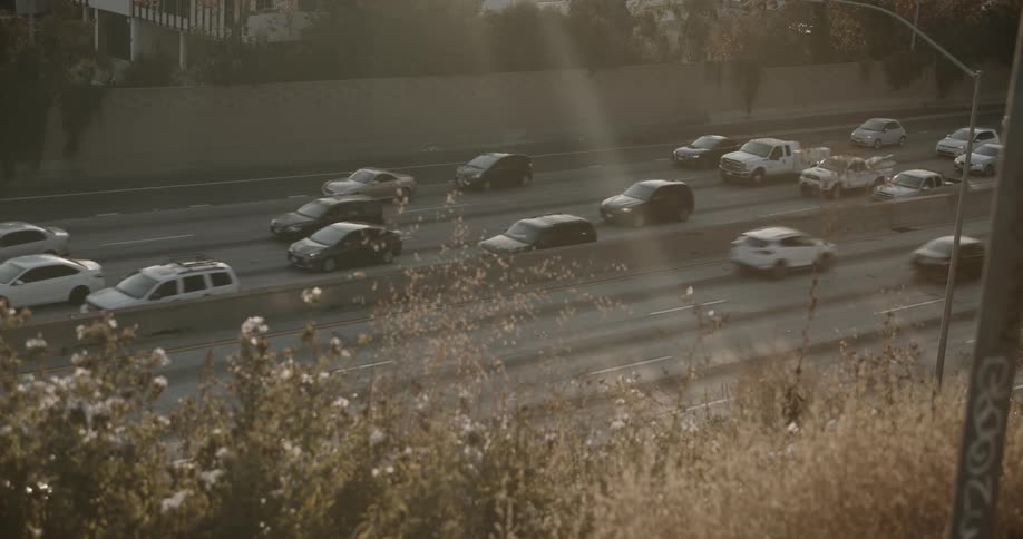 A freeway with several lanes is full of vehicles moving along while one directing is free of traffic congestion but the other is not