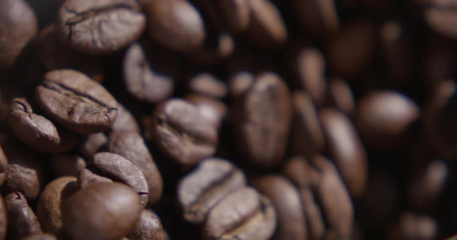 Coffee beans falling down a funnel