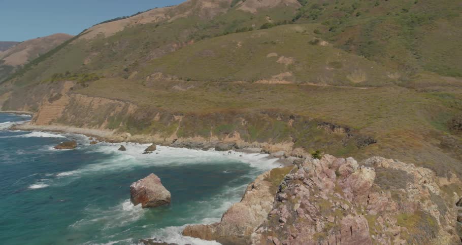 Landscape view of the the water meeting a hillside