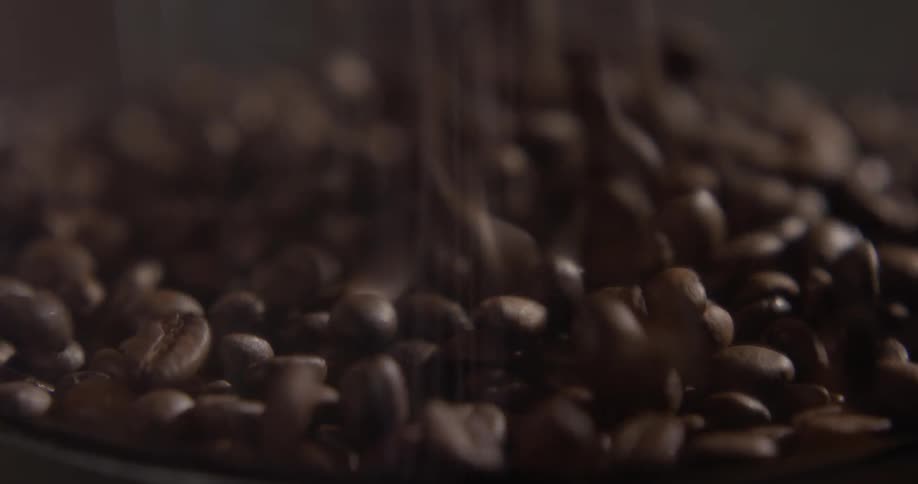Coffee beans being poured in a to a container